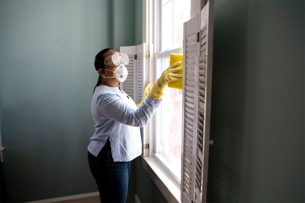 photo of woman cleaning window