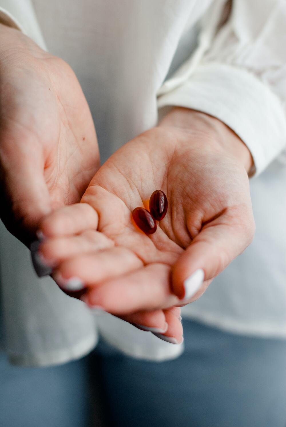 photo of hand holding pills