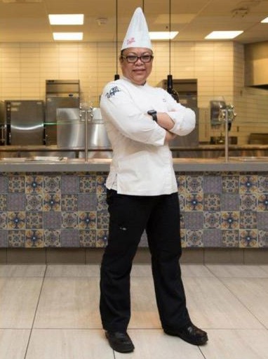 Filipino chef standing in kitchen