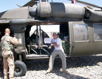 Mark Sigler sitting on a military helicopter