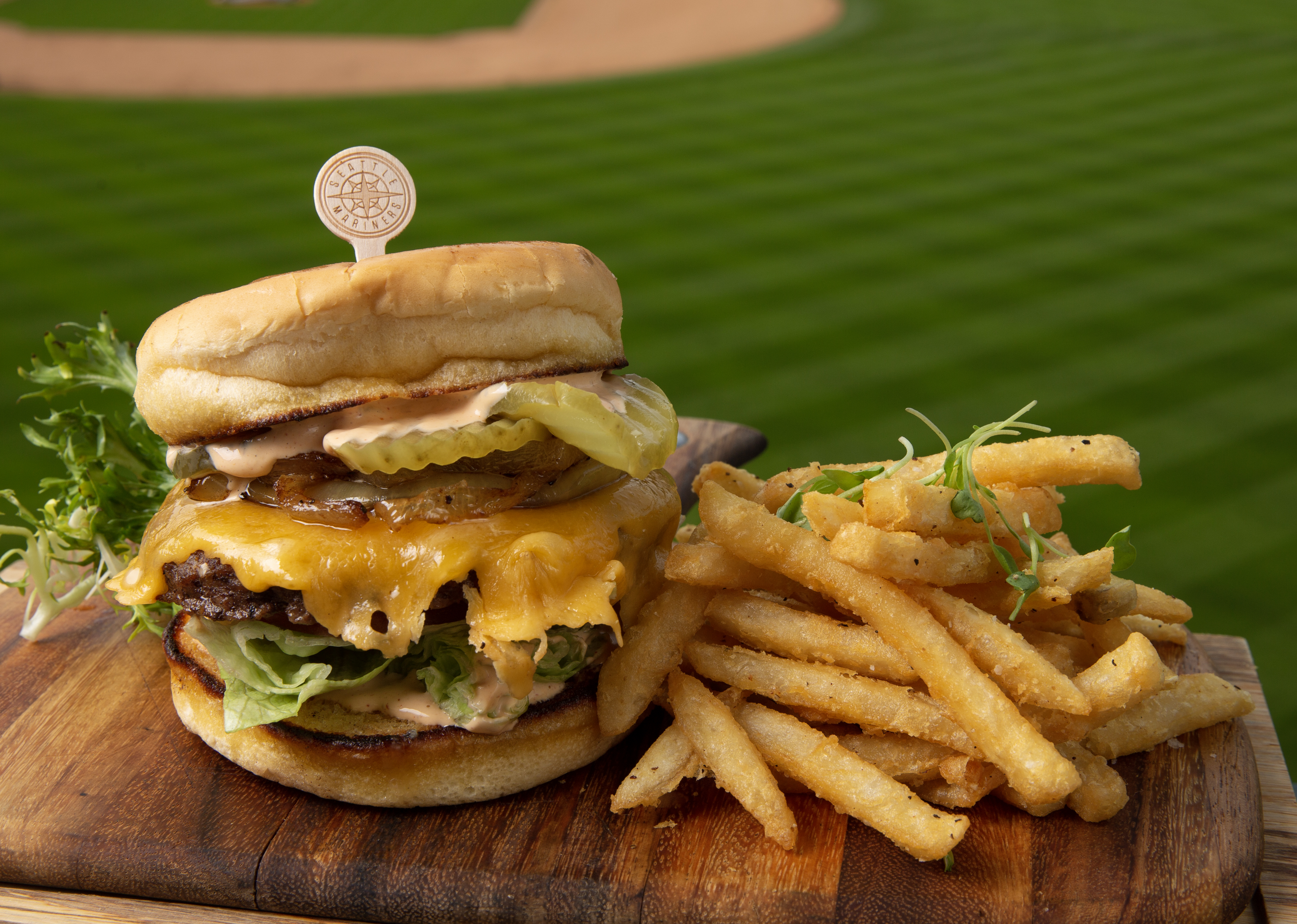tall burger and fries at baseball stadium